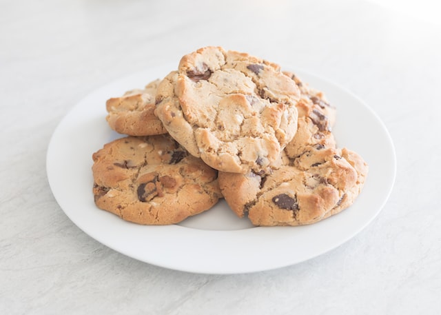 A stack of chocolate chip cookies on a white plate